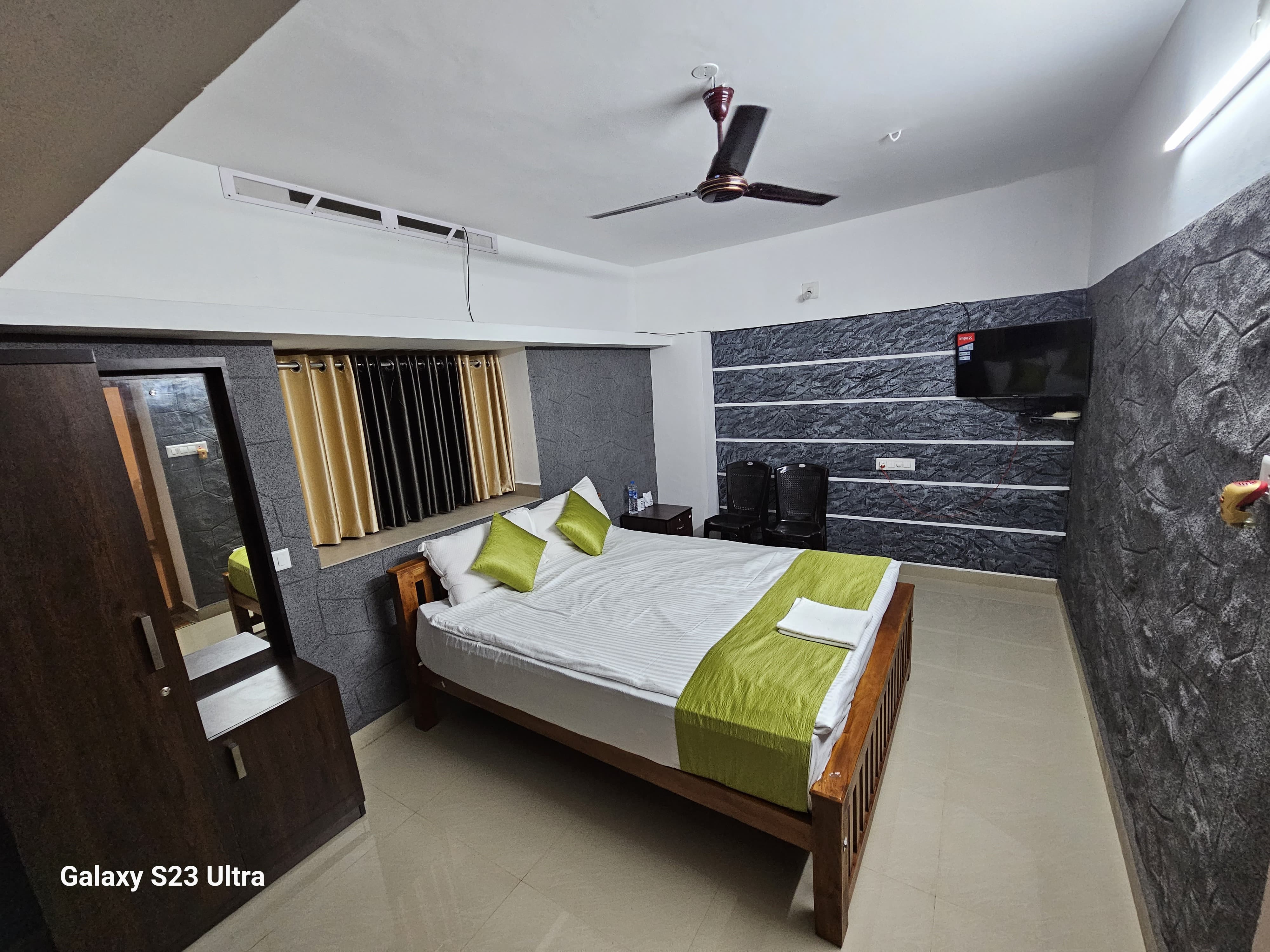 Cozy bedroom interior with traditional Kerala wooden furniture and clean linens